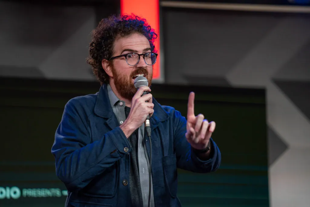 Joe Bolter on stage with a microphone